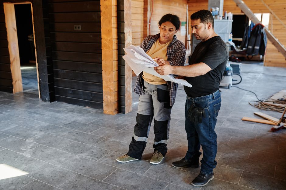 General contractor reviewing blueprints for a whole home remodel